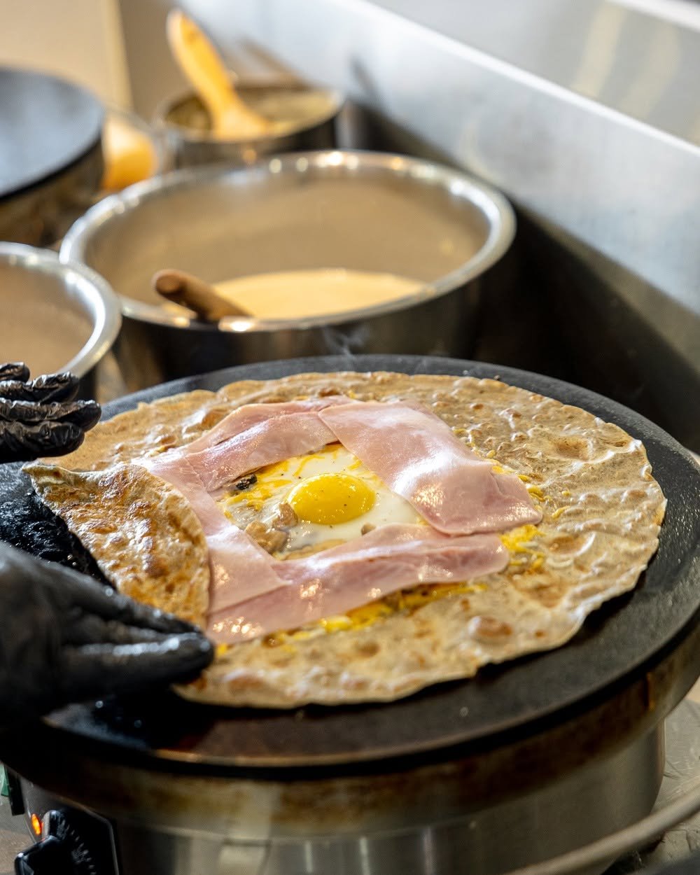 A buckwheat galette cooking on the billig griddle